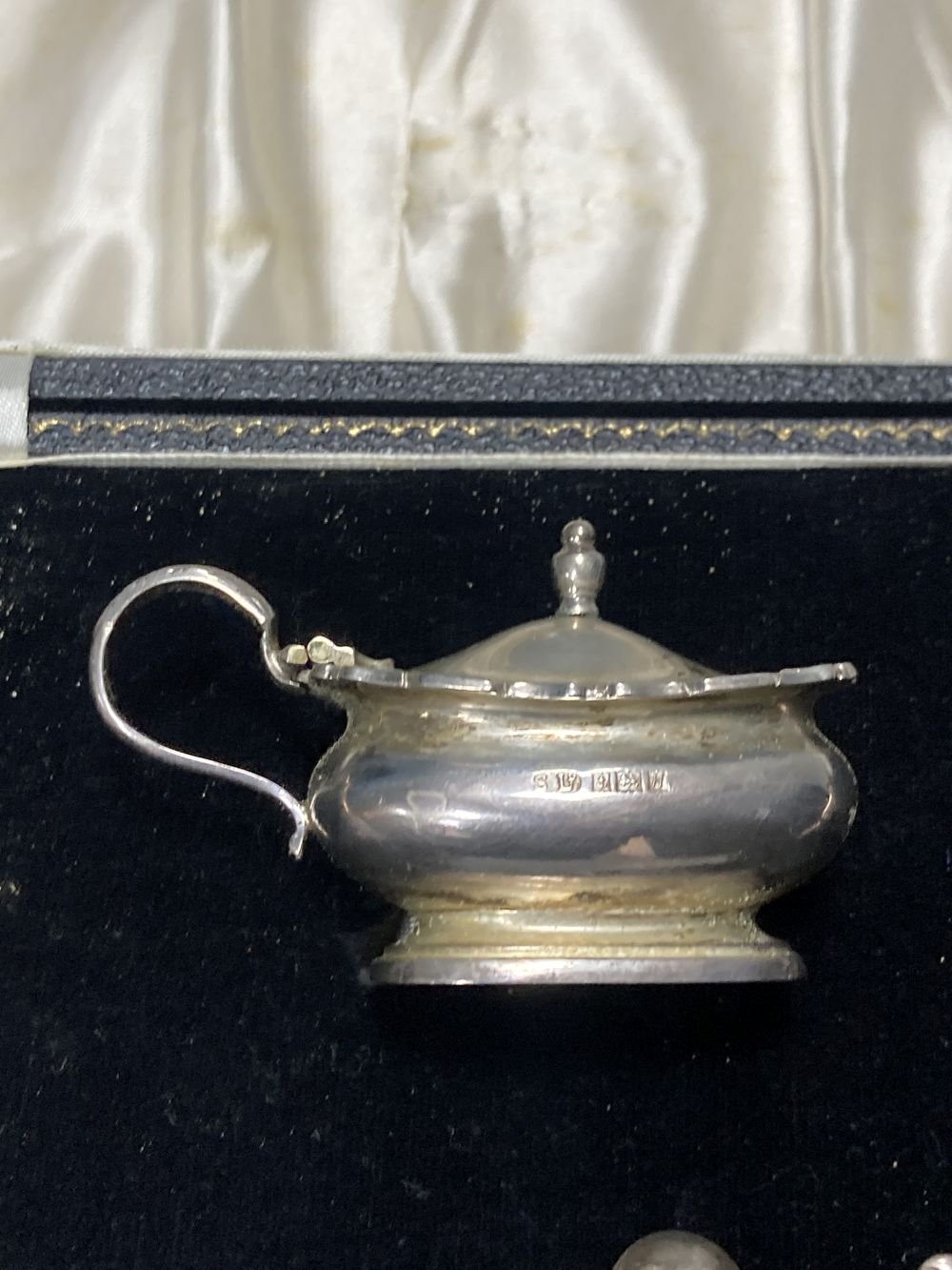 A late 1950s cased silver five piece condiment set, with three spoons, Birmingham, 1957.